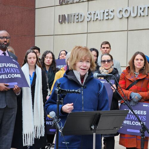 Sen. Tina Smith, D-Minn., accompanied by refugee rights attorneys and supporters, speaks with reporters outside the federal courthouse in Minneapolis on Thursday, Feb. 19, 2026, following a hearing on whether a federal judge should extend a temporary order that protects Minnesota refugees lawfully in the U.S. from being arrested and deported. (AP Photo/Steve Karnowski)