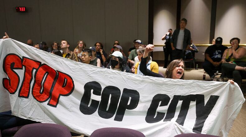 Protestors hold a banner and shout, "Stop Cop City," during the public comment portion of the Atlanta City Council ahead of the final vote to approve legislation to fund the training center at Atlanta City Hall, on Monday, June 5, 2023, in Atlanta. (Jason Getz/The Atlanta Journal-Constitution/TNS)