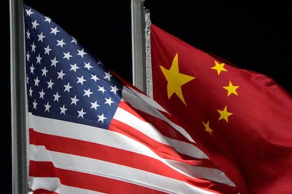 FILE - The American and Chinese flags wave, Feb. 2, 2022, in Zhangjiakou, China. (AP Photo/Kiichiro Sato, File)