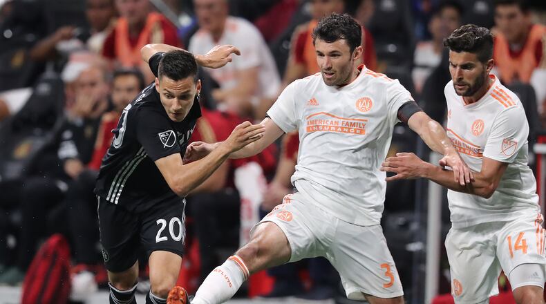 Atlanta United defender Michael Parkhurst kicks the ball away from Sporting Kansas City forward Daniel Salloi during the second half in a MLS soccer match on Wednesday, May 9, 2018, in Atlanta. Curtis Compton/ccompton@ajc.com