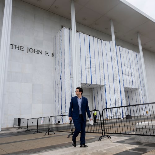 People walk near the tarp covered front entrance of the Kennedy Center for the Performing Arts before the start of the 27th Annual Mark Twain Prize for American Humor Celebrating Bill Maher, Sunday, June 29, 2026, in Washington. (AP Photo/Kevin Wolf)
