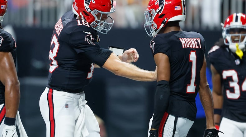 Atlanta Falcons wide receiver Darnell Mooney (1) celebrates with quarterback Kirk Cousins (18) after his touchdown during the first half of a game last year against the Tampa Bay Buccaneers at Mercedes-Benz Stadium in Atlanta.
(Miguel Martinez/ AJC)