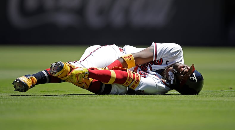 Ronald Acuna grabs his left ankle in the seventh inning of a game against the Toronto Blue Jays on Thursday at Truist Park.  (AP Photo/Ben Margot)