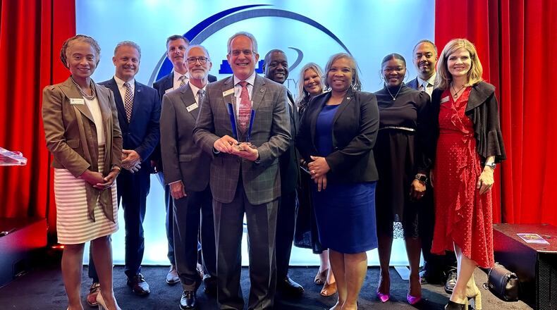 Community Impact Awards Lawrenceville Officials left to right: Marlene Taylor-Crawford, Councilmember; Chuck Warbington, City Manager; John Mullin, Chief of Police; Glenn Martin, Councilmember; David Still, Mayor; Austin Thompson, Councilmember; Jen Young, Impact46 Executive Director; Victoria Jones, Councilmember; Jasmine Billings, Community Development Manager; Marcus Thorne, ReCAST Program Manager; Melissa Hardegree, Director of Community Relations & Chief Communications Officer. (Courtesy City of Lawrenceville)