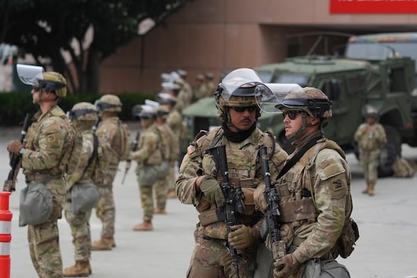 U.S. National Guard are deployed outside the federal prison in downtown Los Angeles, Sunday, June 8, 2025, following a immigration raid protest the night before. (AP Photo/Jae Hong)