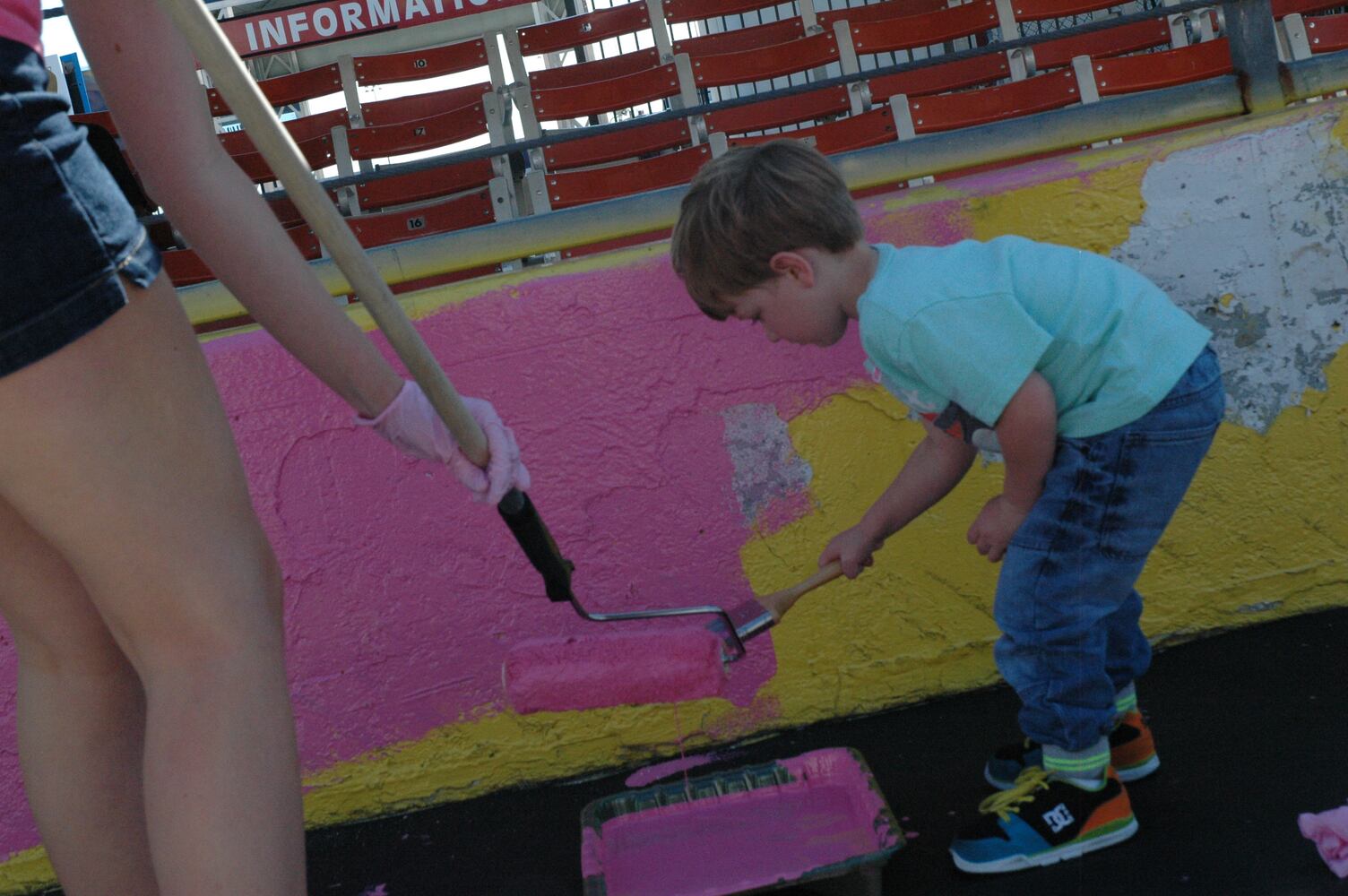IMAGES: NASCAR drivers, breast cancer survivors paint pit road pink