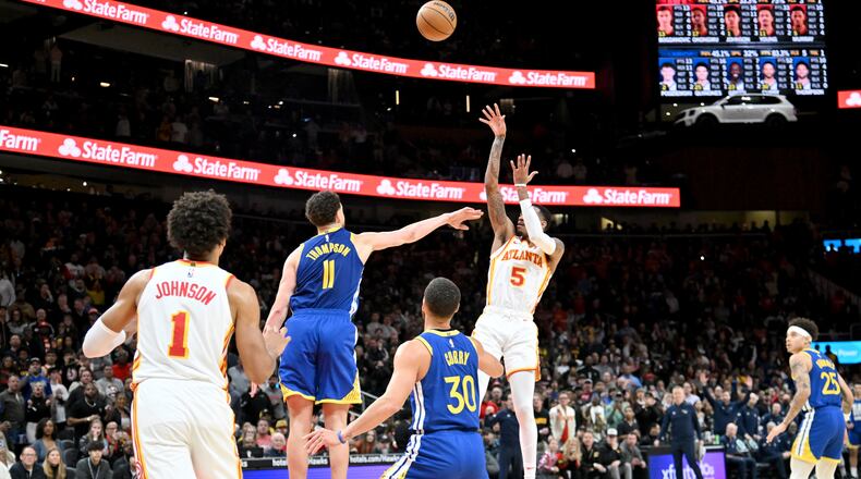 Atlanta Hawks guard Dejounte Murray (5) gets off a shot over Golden State Warriors guard Klay Thompson (11) to tie the game at 123 - 123 and send it to overtime against the Golden State Warriors in an NBA basketball game at State Farm Arena, Saturday, February 3, 2024, in Atlanta. Atlanta Hawks won 141-134 in overtime. (Hyosub Shin / Hyosub.Shin@ajc.com)