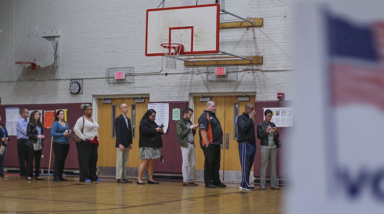 Voters line up to cast ballots at Henry W. Grady High School in Atlanta for Georgia’s presidential primary in 2016. The state’s primary for 2020 will not be scheduled until new voting machines are put in place. JOHN SPINK / JSPINK@AJC.COM