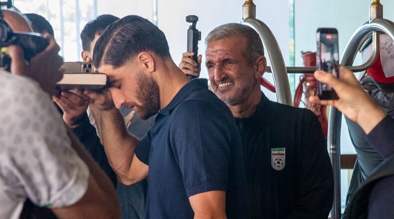 Iran national soccer team member Alireza Jahanbakhsh touches his forehead to the Quran as he departs from the Tijuana Marriott in Tijuana, Mexico on Saturday June 20, 2026. (AP Photo/Gabriela Aoun Angueira)