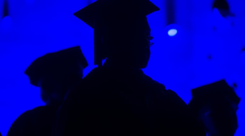 In this May 31, 2014, file photo, members of the graduating class and faculty attend the Savannah College of Art and Design commencement in Atlanta. For the first time on record, living with parents is now the most common arrangement for Americans ages 18 to 34, an analysis of Census data by the Pew Research Center has found.