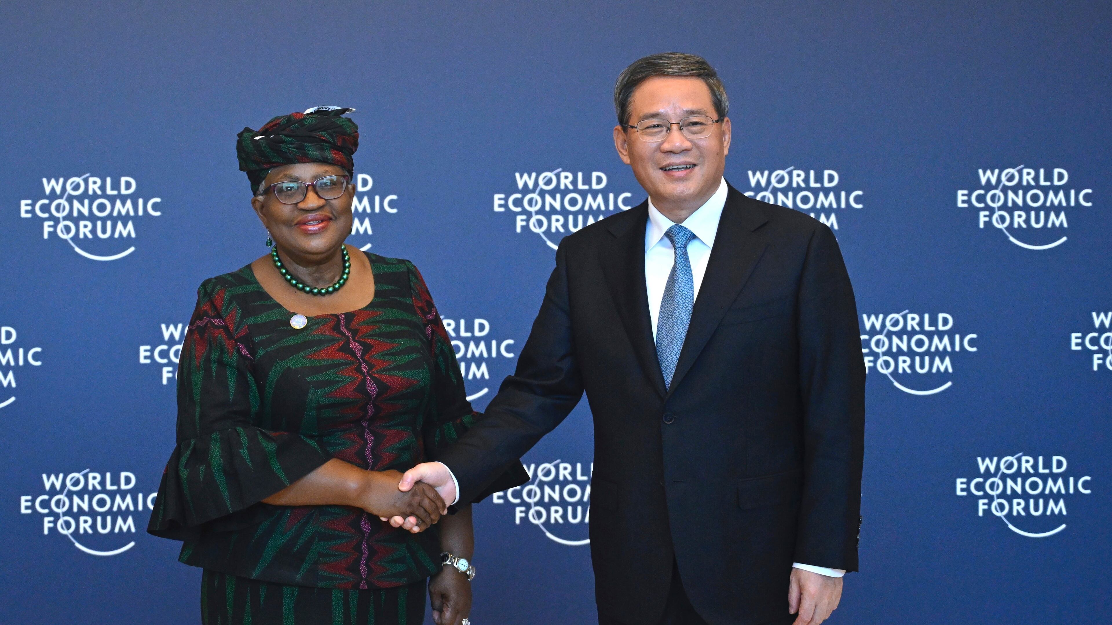 FILE - Chinese Premier Li Qiang, right, shakes hands with Director-General of the World Trade Organization Ngozi Okonjo-Iweala, in Tianjin, ahead of the annual World Economic Forum New Champions meeting Monday, June 26, 2023. (Wang Zhao/Pool Photo via AP, Filer)