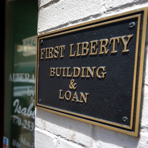A person walks into the store next to First Liberty Building & Loan in downtown Newnan on Wednesday, July 2, 2025. Brant Frost IV shut down First Liberty on June 27, less than two weeks before the U.S. Securities and Exchange Commission filed suit against him and his company. Since then, a federal judge has frozen the company's assets. (Arvin Temkar/The Atlanta Journal-Constitution/TNS)