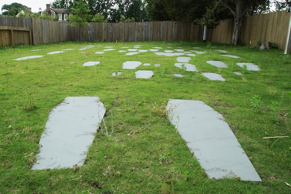 Casket-shaped stones mark the 62 graves identified at the original site of the First Baptist Church of Williamsburg in Williamsburg, Va., on May 30, 2025. (AP Photo/Allen G. Breed)