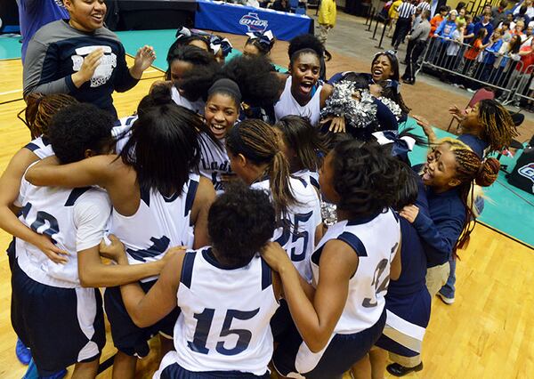 MARCH 6, 2014 MACON Redan Raiders players celebrate after the game. Coverage of the Class AAAA girls basketball championship between Redan Raiders and Columbus Blue Devils at the Macon Coliseum Thursday, March 6, 2014. Redan won 63-53 over the Columbus Blue Devils. KENT D. JOHNSON / KDJOHNSON@AJC.COM Redan Raiders players celebrate winning the Class AAAA girls basketball championship over the Columbus Blue Devils, 63-53, on Thursday, March 6, 2014, at the Macon Coliseum. (Kent D. Johnson / AJC)