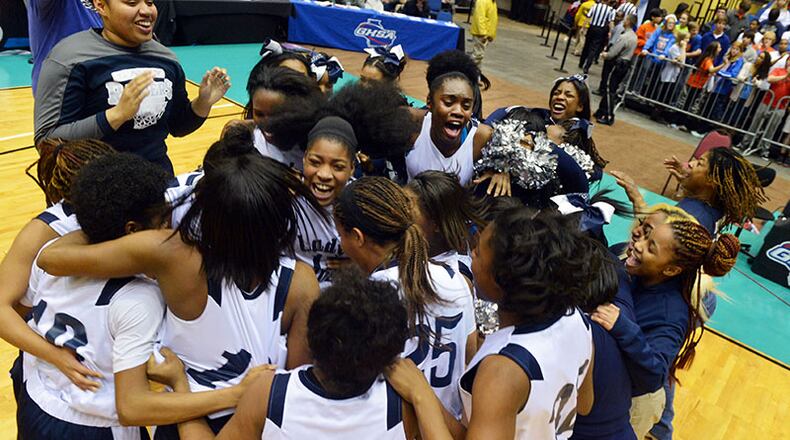 MARCH 6, 2014 MACON Redan Raiders players celebrate after the game. Coverage of the Class AAAA girls basketball championship between Redan Raiders and Columbus Blue Devils at the Macon Coliseum Thursday, March 6, 2014. Redan won 63-53 over the Columbus Blue Devils. KENT D. JOHNSON / KDJOHNSON@AJC.COM Redan Raiders players celebrate winning the Class AAAA girls basketball championship over the Columbus Blue Devils, 63-53, on Thursday, March 6, 2014, at the Macon Coliseum. (Kent D. Johnson / AJC)