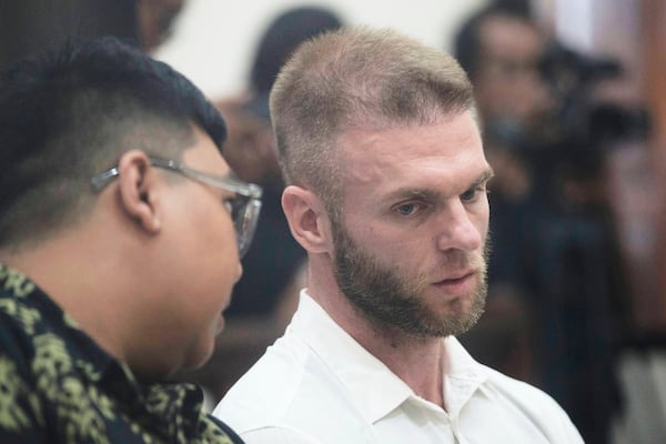British citizen Thomas Parker who is accused of drug offenses listens to his interpreter during his trial hearing at a district court in Denpasar, Bali, Indonesia, Tuesday, May 20, 2025. (AP Photo/Firdia Lisnawati)