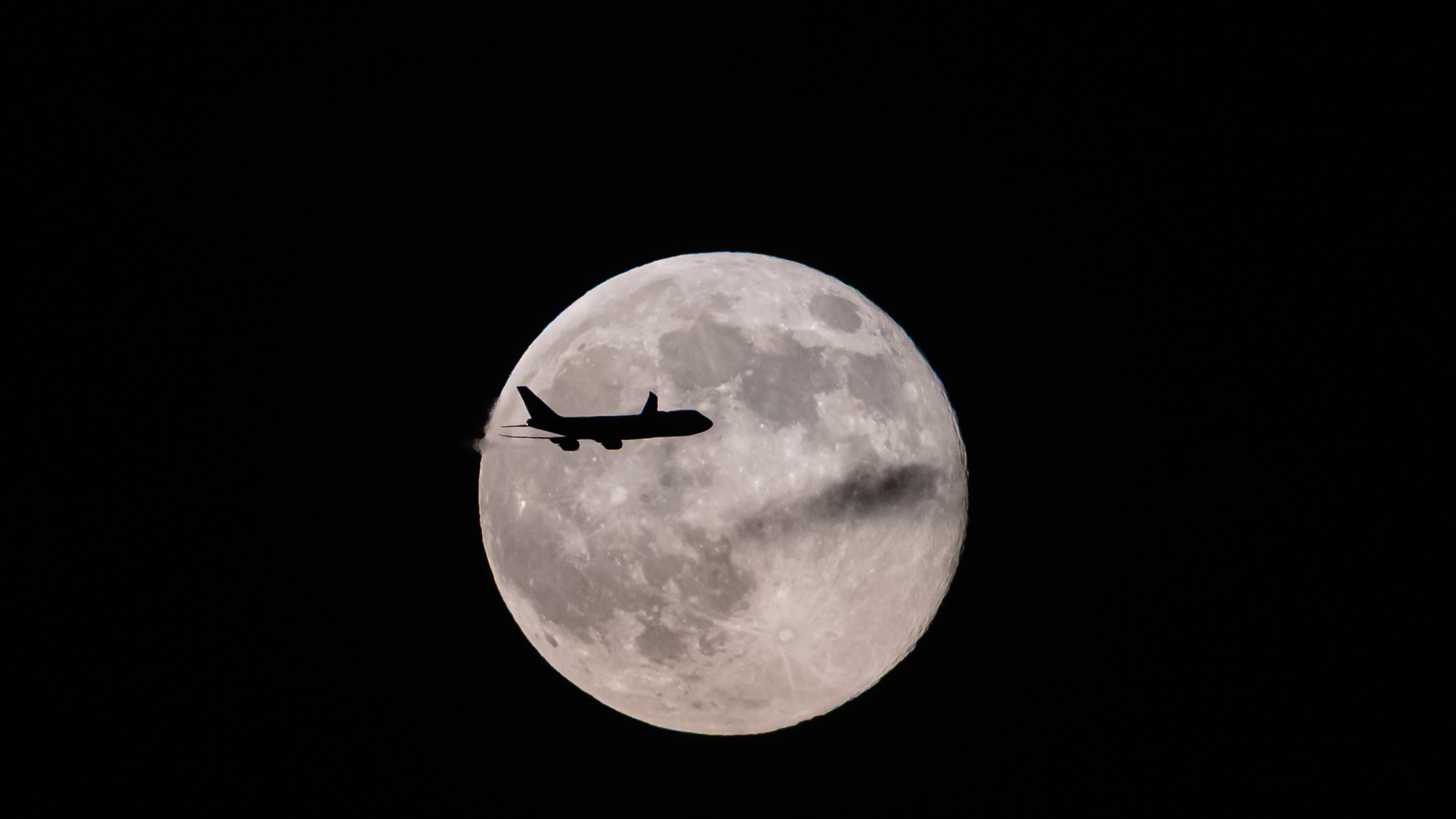 A UPS Boeing 747 inbound from Anchorage, Alaska, passes in front of the supermoon as it approaches Louisville Muhammad Ali International Airport on Wednesday, Nov. 5, 2025, in Louisville, Ky. (AP Photo/Jon Cherry)