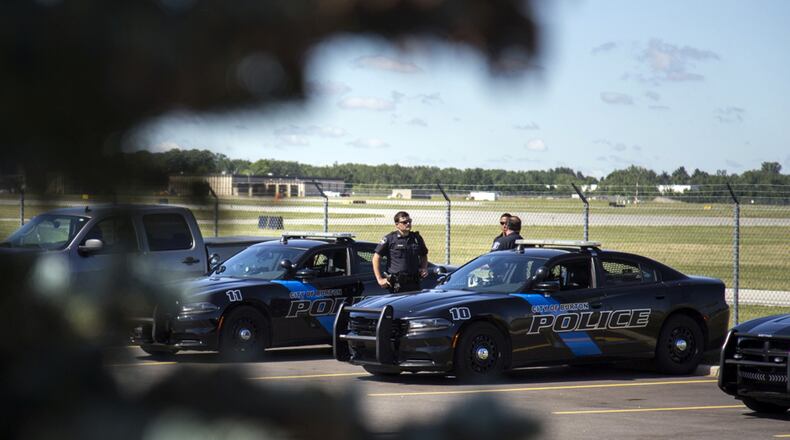 Officers gather at Bishop International Airport, Wednesday, June 21, 2017, in Flint, Mich. Officials evacuated the airport after an officer was stabbed Wednesday. (Shannon Millard/The Flint Journal-MLive.com via AP)
