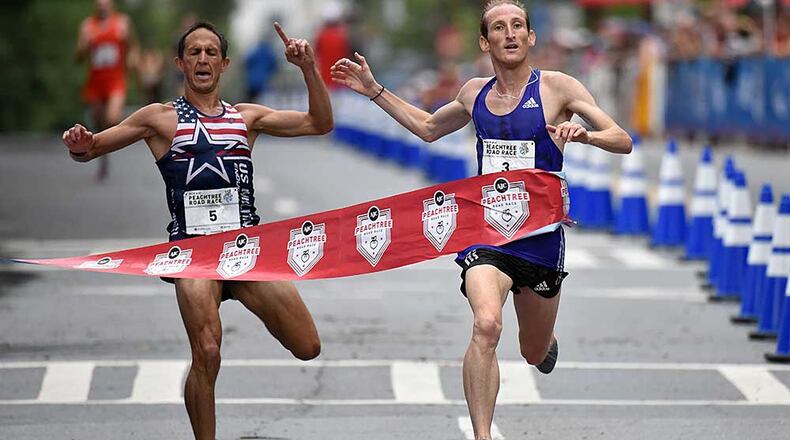 AJC PRR men's winner Scott Overall (right) breaks away from Ben Payne (left), who finished second during the AJC Peachtree Road Race on Saturday, July 4, 2015.
