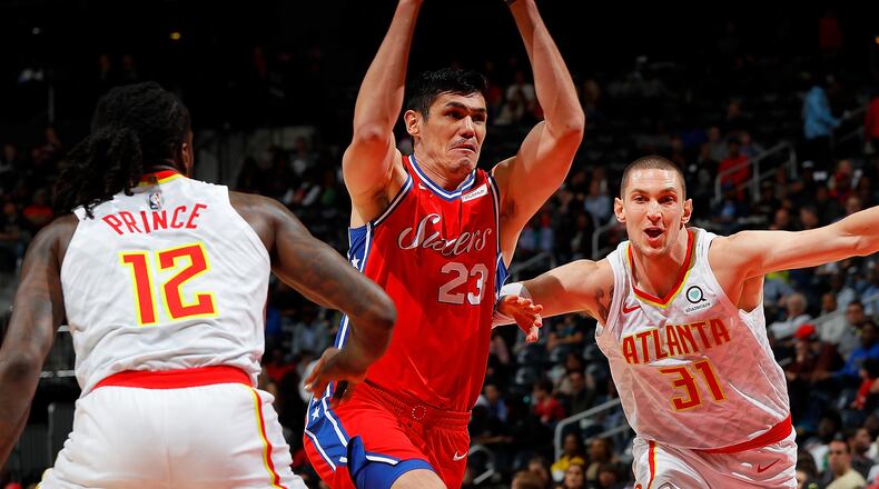 Ersan Ilyasova #23 of the Philadelphia 76ers drives between Taurean Prince #12 and Mike Muscala #31 of the Atlanta Hawks at Philips Arena on March 30, 2018 in Atlanta, Georgia. NOTE TO USER: User expressly acknowledges and agrees that, by downloading and or using this photograph, User is consenting to the terms and conditions of the Getty Images License Agreement. (Photo by Kevin C. Cox/Getty Images)