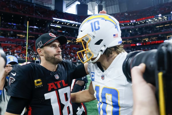 Falcons quarterback Kirk Cousins greets Chargers counterpart Justin Herbert after Sunday's game.