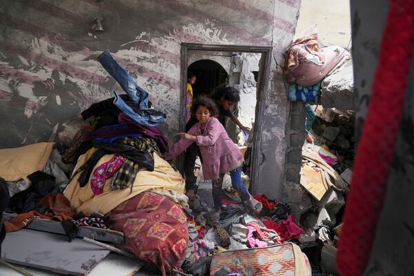 Palestinians children look for good to recover in a house damaged by an Israeli army strike that killed at least five people in Khan Younis, in the southern Gaza Strip, on Thursday, May 1, 2025. (AP Photo/Abdel Kareem Hana)