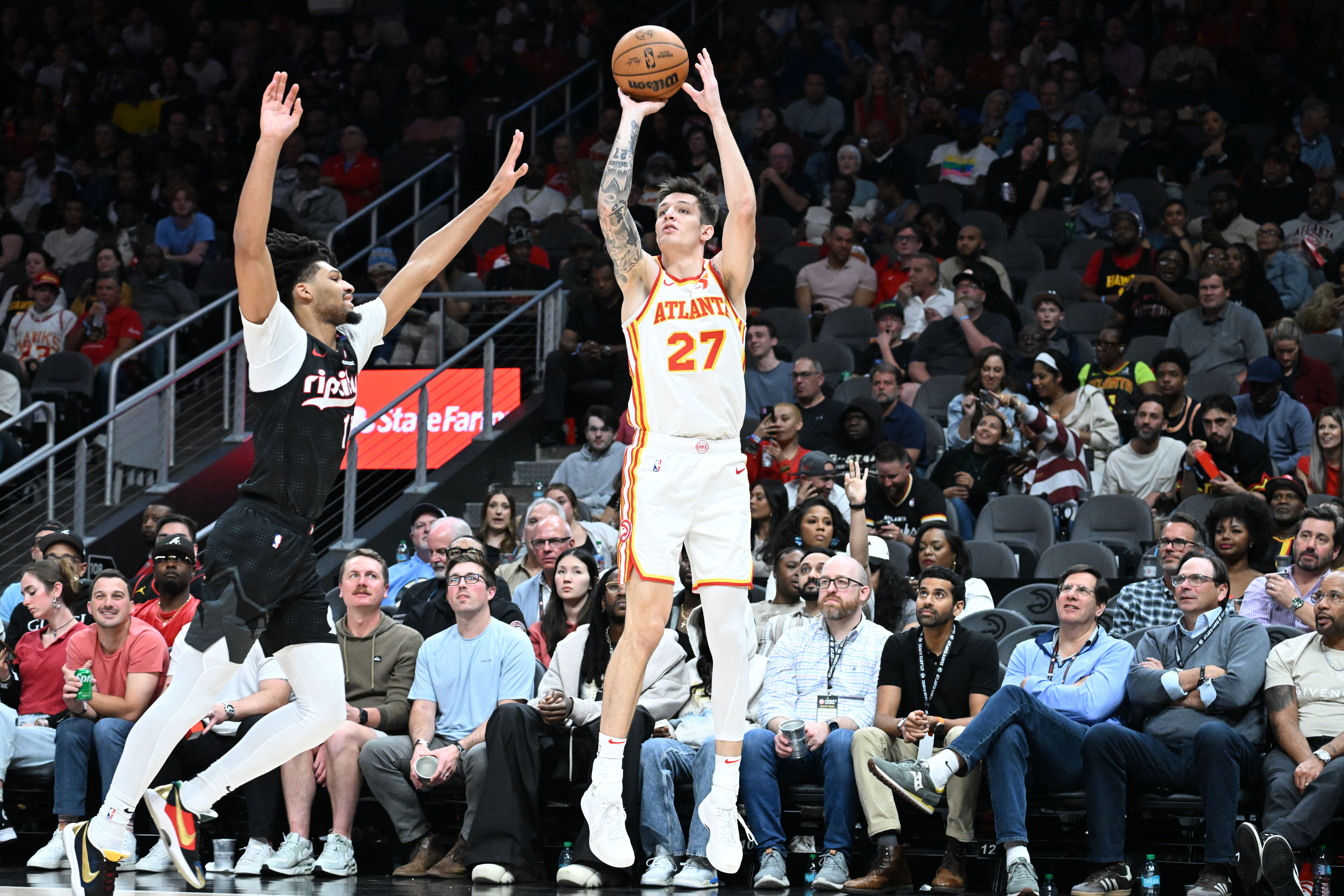 The Hawks traded Vit Krejci (right) — pictured shooting against Portland's Shaedon Sharpe in April — to the Trail Blazers for Duop Reath and two second-round draft picks. (Hyosub Shin/AJC 2025)