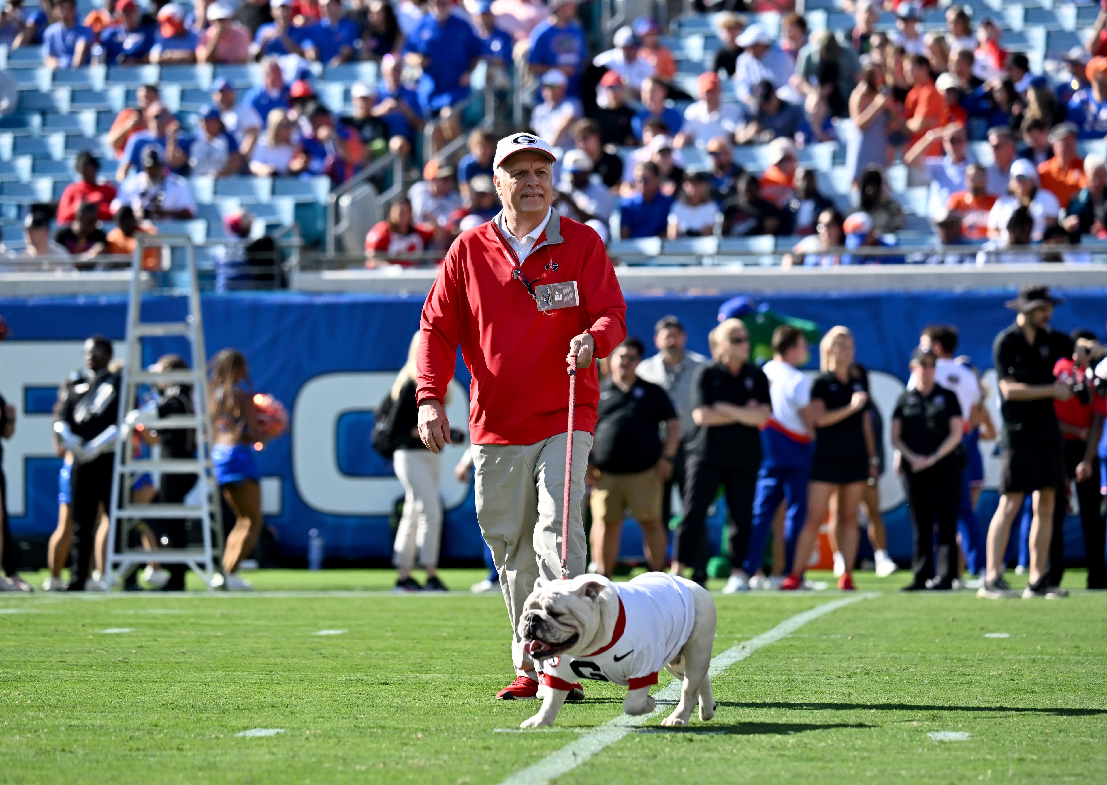 UGA XI, known as Boom, is escorted around the field by his handler Charles Seiler before an NCAA football game between Georgia and Florida at EverBank Stadium, Saturday, November 1, 2025, Jacksonville, Fla. (Hyosub Shin / AJC)