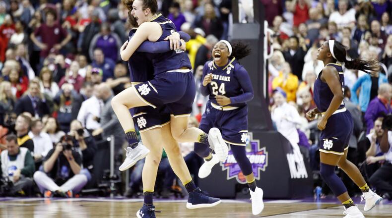Marina Mabrey and Kathryn Westbeld celebrate the game winning basket by their teammate Arike Ogunbowale with 0.1 seconds remaining in the fourth quarter to defeat the Mississippi State Lady Bulldogs in the championship game of the 2018 NCAA Women's Final Four at Nationwide Arena on April 1, 2018 in Columbus, Ohio.