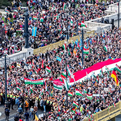 In this photo taken by a drone, participants of the Peace March organized by the pro-government Civil Unity Forum (COF) and its foundation Civil Unity Public Benefit Foundation (COKA) gather at the Buda side of Margaret Bridge in Budapest, Hungary, Thursday, Oct. 23, 2025, on the 69th anniversary of the Hungarian revolution and war of independence against communist rule and the Soviet Union in 1956. (Zsolt Czegledi/MTI via AP)