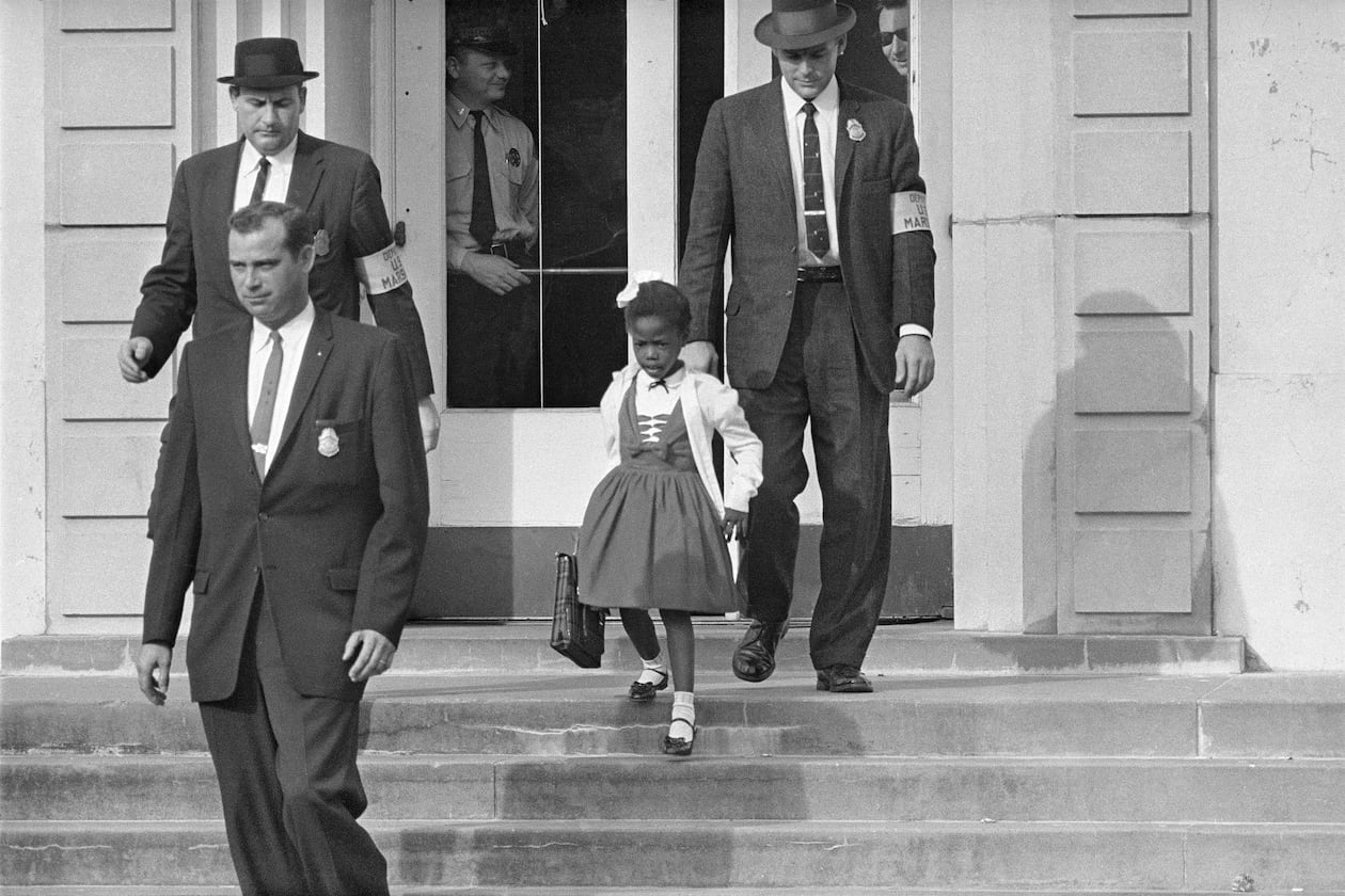 U.S. Deputy Marshals escort 6-year-old Ruby Bridges from William Frantz Elementary School in New Orleans, in this November 1960. In 2014 a statue in her likeness was unveiled on the campus. (AP Photo/File)