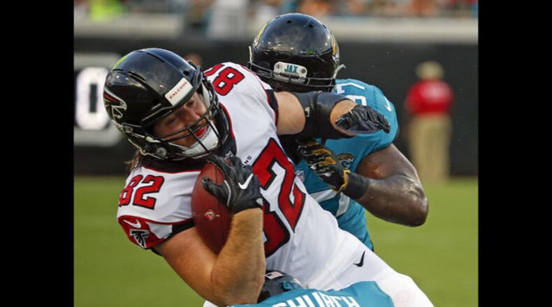 Atlanta Falcons' Logan Paulsen (82) is stopped by Jacksonville Jaguars defensive tackle Malik Jackson, right, after a reception during the first half of an NFL preseason football game Saturday, Aug. 25, 2018, in Jacksonville, Fla. (AP Photo/Stephen B. Morton)