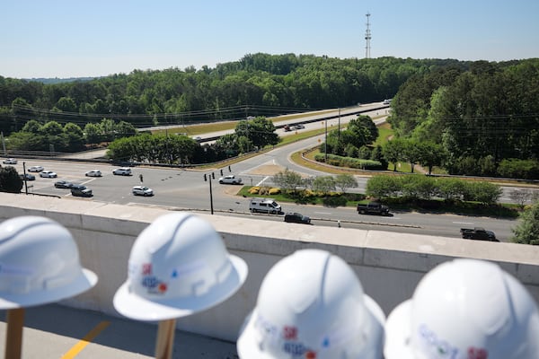 Construction hats are seen at a groundbreaking ceremony in Alpharetta for the official start of a five-year project to add express lanes to Ga. 400 in Fulton and Forsyth counties. (Arvin Temkar/AJC)