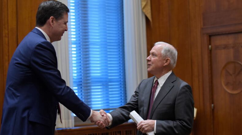 WASHINGTON, DC - FEBRUARY 9:  Attorney General Jeff Sessions, right, shares hands with FBI Director James Comey, left, at the start of a meeting with the heads of federal law enforcement components at the Department of Justice  February 9, 2017 in Washington, DC. A report from The New York Times claims Comey asked Sessions not to let him be alone with President Donald Trump after Trump asked him about the investigation into former national security adviser Michael Flynn. (Photo by Susan Walsh-Pool/Getty Images)