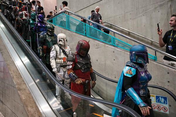 Star Wars fans in different creations of the Boba Fett uniforms attend a fan convention, the Star Wars Celebration in Chiba, near Tokyo, Friday, April 18, 2025. (AP Photo/Hiro Komae)