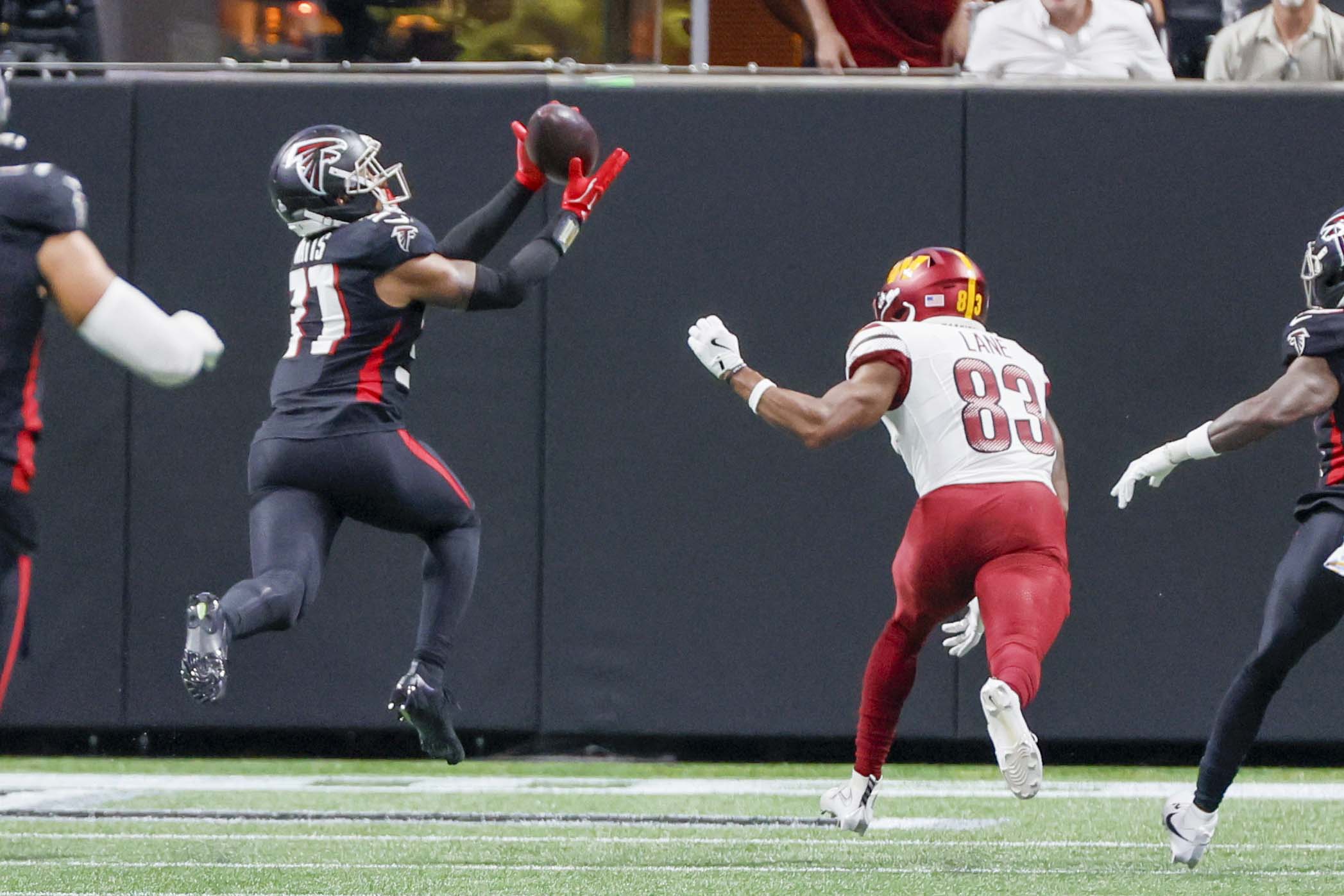 Atlanta Falcons safety Xavier Watts intercepts the ball during the second half of an NFL game against the Washington Commanders at Mercedes-Benz Stadium in Atlanta on Sunday, September 28, 2025. (Miguel Martinez/AJC)