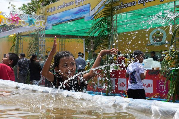 Children take part in the first day of annual water festival also known as "Thingyan," in Naypyitaw, Myanmar, Sunday, April 13, 2025. (AP Photo/Aung Shine Oo)
