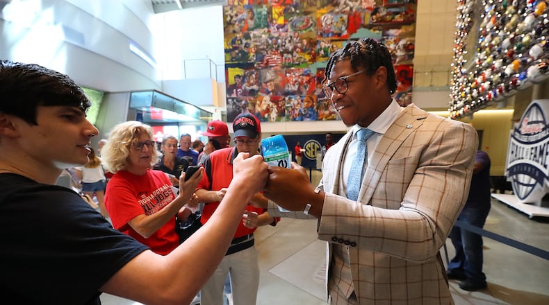 Georgia linebacker Nolan Smith gives a Georgia fan a fist bump as he arrives for SEC Media Days in the College Football Hall of Fame on Wednesday, July 20, 2022, in Atlanta.   “Curtis Compton / Curtis Compton@ajc.com”