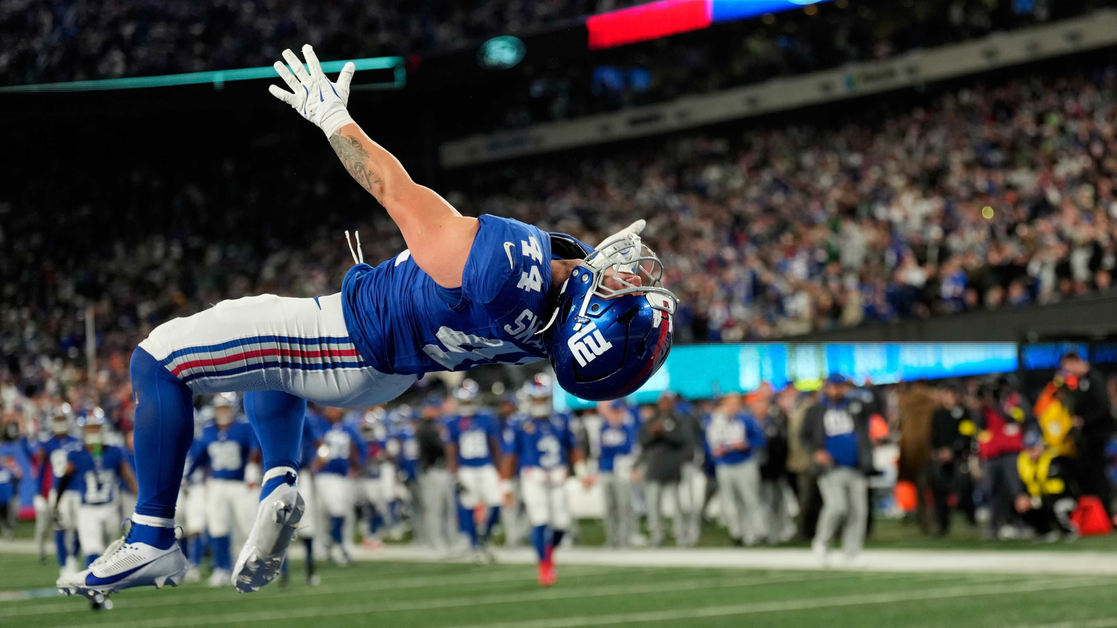 New York Giants' Cam Skattebo reacts after a touchdown during the second half of an NFL football game against the Philadelphia Eagles Thursday, Oct. 9, 2025, in East Rutherford, N.J. (AP Photo/Seth Wenig)