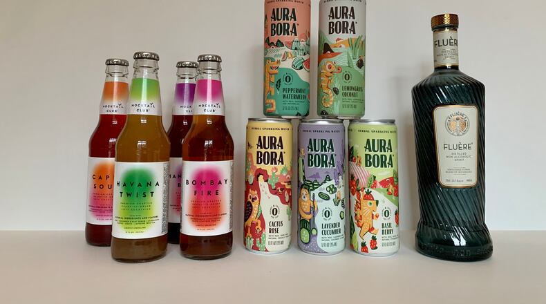 Mocktail Club's bottled drinks, Aura Bora cans of sparkling water and Fluére's distilled spirit are three nonalcoholic options to add to your home bar. Angela Hansberger for The Atlanta Journal-Constitution