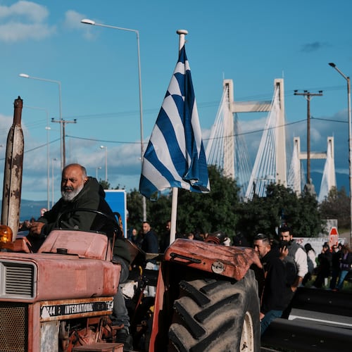 Farmers block the Chalkida Bridge with tractors during a protest over delays in European Union–backed agricultural subsidy payments, on Evia island, Greece, Thursday, Jan. 8, 2026. (AP Photo/Thanassis Stavrakis)