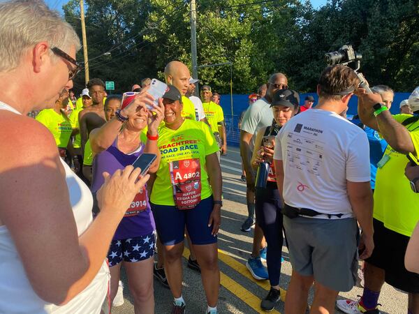 Atlanta Mayor Keisha Lance Bottoms finished the 10K this morning, and was met with requests for selfies. (Photo: Sarah Kallis/AJC)
