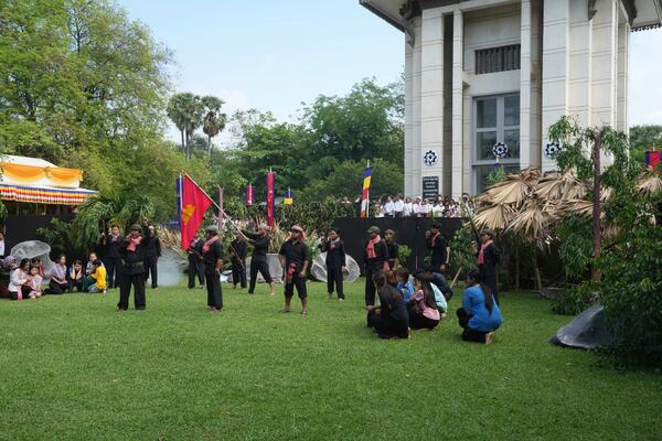 FILE - Cambodian students of Royal University of Fine Arts reenact torture and execution by the Khmer Rouge during their reign of terror in the 1970s, in an event hosted by the ruling Cambodian People's Party to mark the annual Day of Anger at Choeung Ek, a former Khmer Rouge "killing field," on the outskirt of Phnom Penh, Cambodia Wednesday, May 20, 2015. (AP Photo/Heng Sinith, File)