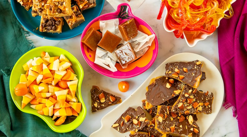 Celebrate spooky season with a DIY project for cooks of all ages. From top left, clockwise: Quick Nut Butter Fudge, Salted Caramels, Gummy Worms, Easy Toffee, and Candy Corn. (Courtesy of Aaliyah Man for The Atlanta Journal-Constitution)