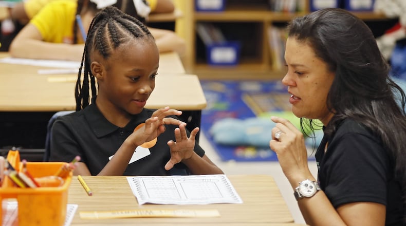 Atlanta Public Schools Superintendent Meria Carstarphen helps a student with a math assignment on the first day of the 2018-2019 school year at Peyton Forest Elementary school.  AJC FILE PHOTO/ BOB ANDRES /BANDRES@AJC.COM