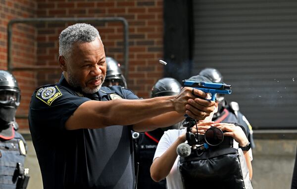 Atlanta Public Schools police Chief Ronald Applin demonstrates discharging a handgun during a training drill introducing two new security units — a tactical team and a drone team — at Atlanta Public Schools’ Brewer Training Center on Tuesday, July 21, 2026, in Atlanta. (Hyosub Shin/AJC)