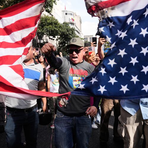 Government supporters rip an American flag in half during a protest in Caracas, Venezuela, Saturday, Jan. 3, 2026, after U.S. President Donald Trump announced that U.S. forces had captured President Nicolás Maduro and first lady Cilia Flores. (AP Photo/Ariana Cubillos)