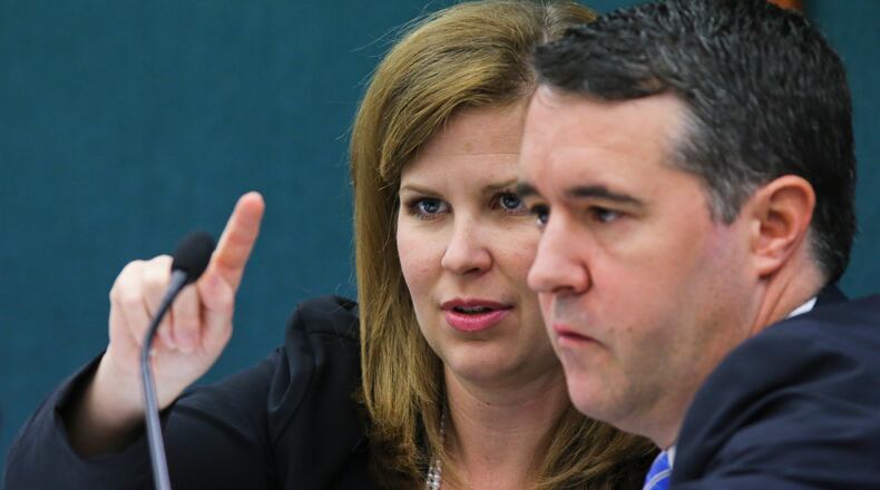 September 30, 2014 Atlanta: Commission Chairwoman, Hillary Stringfellow (left) points out some information to fellow commissioner, Lawton Jordan (right) at the State Ethics Commission meeting, formally called Georgia Government Transparency & Campaign Finance Commission at the Coverdell Legislative Office Building at 18 Capitol Square Tuesday, Sept. 30, 2014. JOHN SPINK/JSPINK@AJC.COM