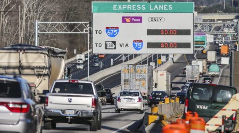 Northbound commuters drive past the lowered gates just south of Hwy 138 along the new I-75 South Metro Express Lanes in Clayton and Henry counties. JOHN SPINK /JSPINK@AJC.COM