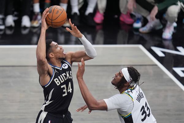 Milwaukee Bucks forward Giannis Antetokounmpo (34) shoots the ball over Indiana Pacers center Myles Turner (33) during the second half in Game 5 of an NBA basketball first-round playoff series in Indianapolis, Tuesday, April 29, 2025. (AP Photo/Michael Conroy)